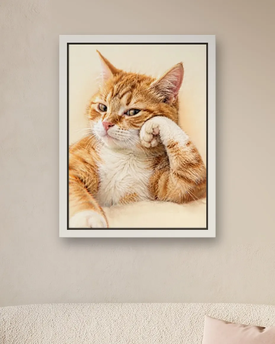 An orange cat's Soft Pastel portrait as a framed canvas on a bedroom wall above a cream loveseat